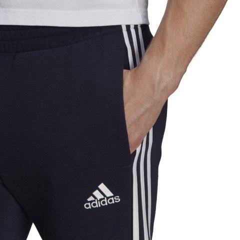 Adidas Spodnie męskie adidas Essentials Tapered Cuff 3 Stripes granatowe GK8977